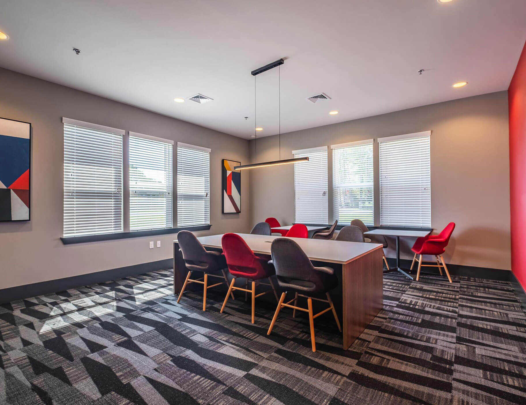 meeting room with patterned carpet and colorful chairs and wall accents